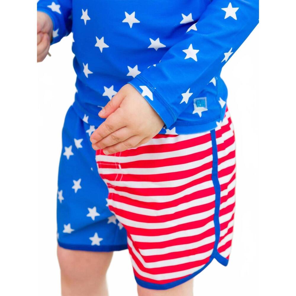 NEW RUFFLEBUTTS boys stars & stripes dolphin hem swim trunks in blue